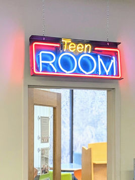 Neon sign reading Teen Room