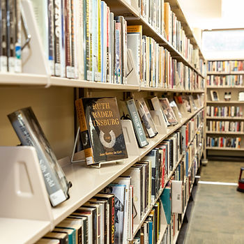 A picture of a section of books at orion library with one shelf with many books prominently displayed