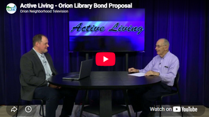 Library Director Chase McMunn sitting at a table with Active Living host George Sinnott.
